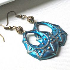 "Blue Hoop Earrings - Hand painted Blue with a Turquoise cast, and Gold Highlights Oval Embossed Brass Stampings. They are suspended from Antiqued Brass Filigree Beads. Earrings are 35mm x 28mm (just under 1.5\" long x just over 1\" at widest point) and have hollow backs. These are lightweight. Earrings measure just under 2.5\" from top of earwires to bottom. Antiqued brass earwires See my Patina Collection for similar items. http://www.etsy.com/shop/mcstoneworks?section_id=6573408" Blue Hoop Earrings, Beads Earrings, Gold Highlights, Lightweight Earrings, Earrings Boho, May 21, Boho Earrings, Antique Brass, Silver Bracelet