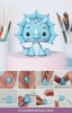 there is a blue toy that looks like a baby dragon sitting on top of a cake