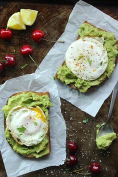 avocado toast with poached egg on top and cherries around it