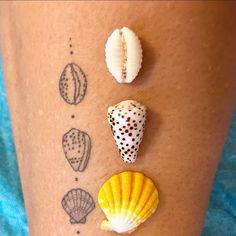 three seashells are on the side of a woman's leg with dots