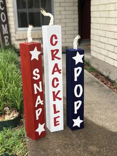 three red, white and blue wooden signs with the words cracker pop on them