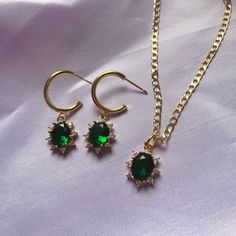 ♥ All photos are taken by myself using the real products, the rights to these photos are reserved  ♥ A gorgeous pair of half hoop gold plated brass stud earrings with a dark green gemstone.  These come with a complementary velvet gift bag, making it ideal as a gift or a treat for yourself.  The necklace is made from 24k gold plated brass and is 18 inches in length. This is secured with a lobster clasp. The earrings are also made from gold plated brass and are a total length of 3.8cm. Please note as only a limited number of stock are created, if you see that the jewellery set is out of the stock and the necklace and earrings are still available, please send me a message and I will alter this on the page. Dark Green Jewelry, Dark Green Gemstone, Prom Jewelry, Jewellery Sets, Green Jewelry, Earring Display, Green Crystal, Jewellery Set, Green Gemstones