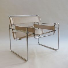 a pair of chairs sitting next to each other on a white surface with no one in it