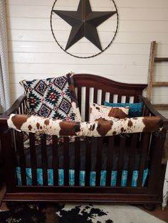 a baby crib with pillows and a star on the wall