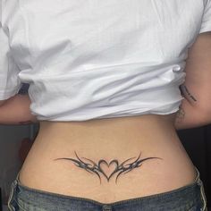 a woman's lower back with tattoos on her stomach