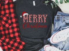 This Merry Christmas Candy Cane Shirt gives elf vibes! This tee features a candy cane stripe font and is perfect for a Christmas crewneck. Plus, it's unisex sizing makes it great for matching Christmas squad member shirts or Christmas family trip shirts. This classic unisex jersey short sleeve tee fits like a well-loved favorite. Soft cotton and quality print make users fall in love with it over and over again. These t-shirts have-ribbed knit collars to bolster shaping. The shoulders have taping Elf Vibes, Candy Cane Shirt, Family Trip Shirts, Trip Shirts, Candy Cane Stripes, Christmas Crewneck, Road Design, Family Trip, Christmas Candy Cane