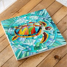 an image of a colorful turtle in the ocean on a wooden floor with wood planks