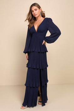 Elegance and poise come naturally with a look like the Lulus Graceful Finesse Navy Blue Pleated Long Sleeve Maxi Dress! Lightweight woven chiffon shapes a lightly gathered bodice, a plunging V-neck (and back), and semi-sheer balloon sleeves with elastic at the cuffs. The high, banded waist tops an A-line skirt that boasts flouncy pleated tiers as it cascades down to a sweeping maxi hem. Hidden back zipper/clasp. Fit: This garment fits true to size. Length: Floor length. Size medium measures 60.5 Elegant Tiered Chiffon Dress, Fitted V-neck Chiffon Dress With Pleated Bodice, Elegant Tiered Maxi Dress With Ruched Bodice, Elegant Tiered Maxi Dress For Date Night, Elegant Blue Tiered Maxi Dress, Long Navy Blue Bridesmaid Dresses, Long Sleeve Bridesmaid Dress, Navy Blue Bridesmaid Dresses, Gathered Bodice