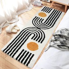 a white rug with black and orange designs on it