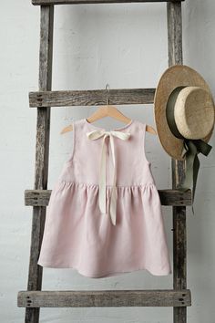 Smock dress is made of 100% soft medium weight linen.  Details: - Choose size and embroidery in the drop down menu - Colour: Baby pink - Composition: 100% Oeko-Tex certified linen - Sleeveless  - Gathered waist  - White ribbon in the back - Medium weight linen - Linen care: machine wash gentle; tumble dry low, ironing optional - The price is for one smock dress, other pictured items are not included Sleeveless Linen Dress, Dress Linen, Dress For Girls, Girls Dresses Summer, Dress Girl, Flower Girl Dress, Smock Dress, Linen Dresses