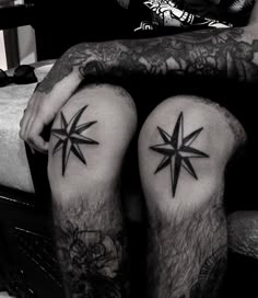 two men with tattoos on their legs sitting next to each other and one has a star tattoo on his leg