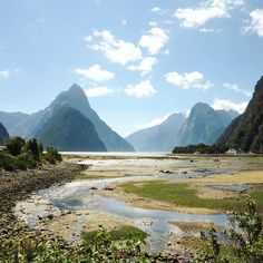 a river running through a valley surrounded by mountains