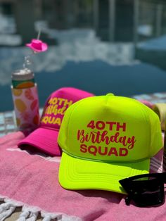 a yellow hat and sunglasses sitting on top of a towel next to a water bottle