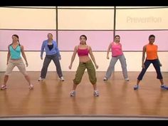 a group of people standing on top of a wooden floor in front of a wall