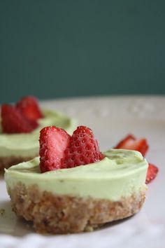 two small desserts with strawberries on top