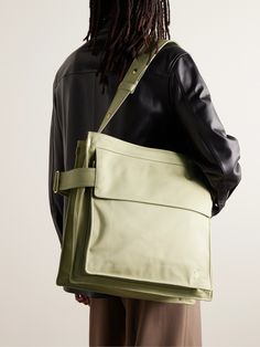 Inspired by its iconic trench coats, Burberry's tote bag is made from durable gabardine and has a wide, cinching strap with a polished gold-tone buckle shaped like a 'B'. The substantial size means it'll work well for an overnight trip. Burberry Mens Bag, Men’s Bags, Festival Tote Bag, Mens Work Bags, Tote Bag Men, Mens Designer Backpacks, Tote Bag For Men, Mens Tote Bag, Porter Bag