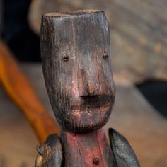 a close up of a wooden statue with holes in it