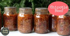 several jars filled with food sitting on top of a table