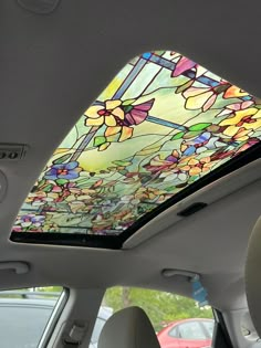 the interior of a car with a stained glass skylight in it's center window