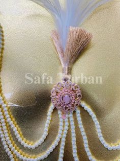 Elevate your wedding look with our stunning Wedding Kalgi with Pearl string for Groom. Handcrafted with precision, this Kalgi boasts of American Diamond jewelry, beautiful feathers, and pearls.  The Kalgi comes attached with 3 man-made pearl strands on either side to give your turban a regal touch. Safety Pin/Push Pin Attached It is completely handmade and beautifully crafted and stitched Premium Rich Men Kalangi Care Instruction: Don't use perfumes and deodorants directly on the product Traditional Pink Pearl Necklace For Wedding, Festive Pink Pearl Necklace For Wedding, Traditional Pearl White Necklace For Wedding, Kalgi For Groom, Indian Wedding Accessories, Groom Turban, Beautiful Feathers, 3 Man, American Diamond Jewellery