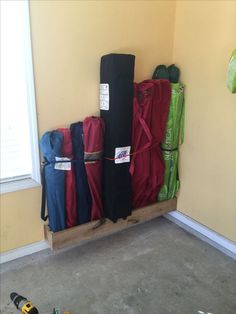 a pile of luggage sitting on top of a wooden pallet next to a window