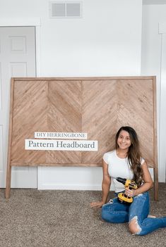 a woman sitting on the floor with a driller in her hand next to a sign that says pattern headboard