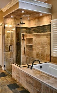 a bathroom with a walk in shower next to a bath tub