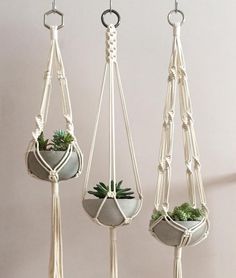 three hanging planters with plants in them