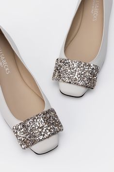 Round toe ballerina flat with tab detail in ivory with glitter tab Chic Slip-on Ballet Flats With Textured Sole, Festive Embellished Closed-toe Flats, Summer Slip-on Flats With Perforations, Formal Textured Sole Slip-on Ballet Flats, Slip-on Flats With Perforations, Artisan Fashion, Glitter Ornaments, Blush And Gold, Unique Materials