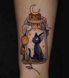 a black cat in a glass jar with a crescent moon tattoo on the arm and leg