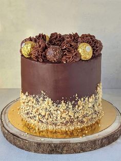 a chocolate cake with gold decorations on top