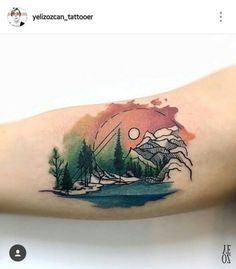 a person with a tattoo on their arm that has trees and mountains in the background