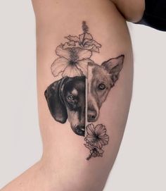 a woman's thigh with two dogs and flowers on it