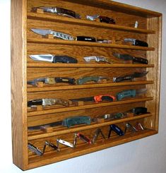 a wall mounted knife holder with many knives on it's sides and several different types of knives in each section