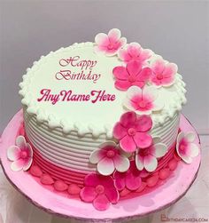 a birthday cake decorated with pink flowers and the words happy birthday to my name here