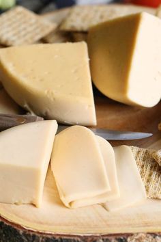 several different types of cheese on a cutting board