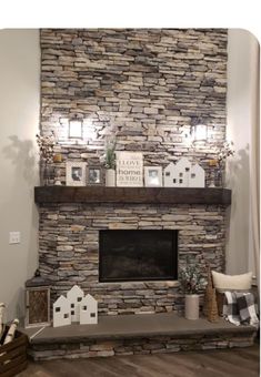 a living room with a stone fireplace and mantle