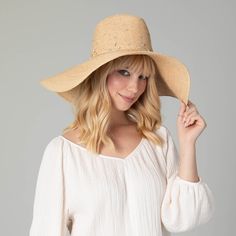 Our Glitz Wide Brim Fedora Sun Hat is a luxurious accessory for your summertime wardrobe. The delicate braid raffia is carefully crafted with attention to detail, and embedded with rhinestones to add a touch of sparkle. The 6" brim offers UPF 50+ sun protection and is adjustable for a perfect fit. Boasting a classic natural color and crafted from 100% premium raffia, this floppy fedora is a must-have for any fashionable collection. Features: Color: NaturalMaterials: 100% RaffiaBrim Size: 6" Brim Elegant Rhinestone Hat For Spring, Elegant Natural Straw Sun Hat, Elegant Summer Hats With Rhinestones, Luxury Straw Hat For Spring Vacation, Elegant Braided Hats For Spring, Elegant Braided Hat For Spring, Luxury Summer Sun Hat, Luxury Brimmed Straw Hat For Spring, Luxury Straw Hat For Vacation