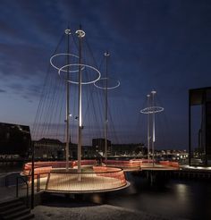 an artistic sculpture is lit up at night