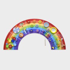 a rainbow shaped wall hanging with lots of different things on it's sides and the top half