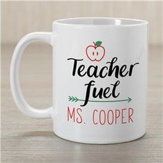 a white coffee mug with teacher fuel ms cooper written on the side and an apple