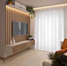 a modern living room with white curtains and wood paneling on the wall, along with a flat screen tv