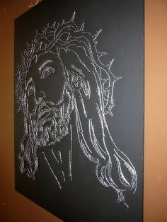 a chalk drawing of jesus christ on a blackboard with white crayon paint