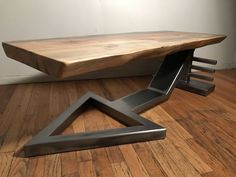 a wooden table sitting on top of a hard wood floor next to a metal frame