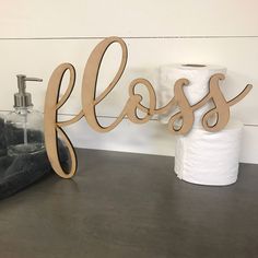 a close up of a toilet paper dispenser near a roll of toilet paper