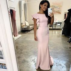 a woman in a pink dress taking a selfie