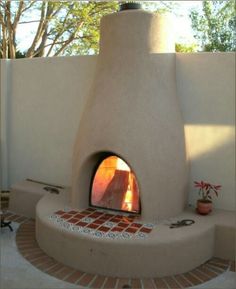 an outdoor pizza oven in the middle of a patio