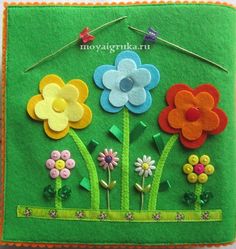 a green felt card with flowers on it