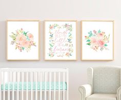 a baby's room with three floral prints on the wall