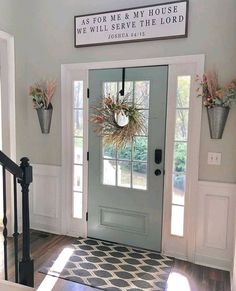 the front door is decorated with wreaths and flowers